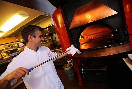 Jackson's Bar and Oven's chef de cuisine Jason Denton cooks pizzas at the restaurant in Santa Rosa, Wednesday, August 28, 2013